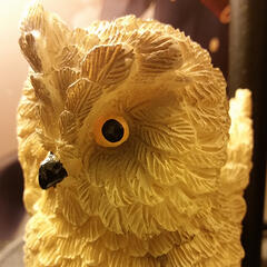 cropped image of a mini owl sculpture.